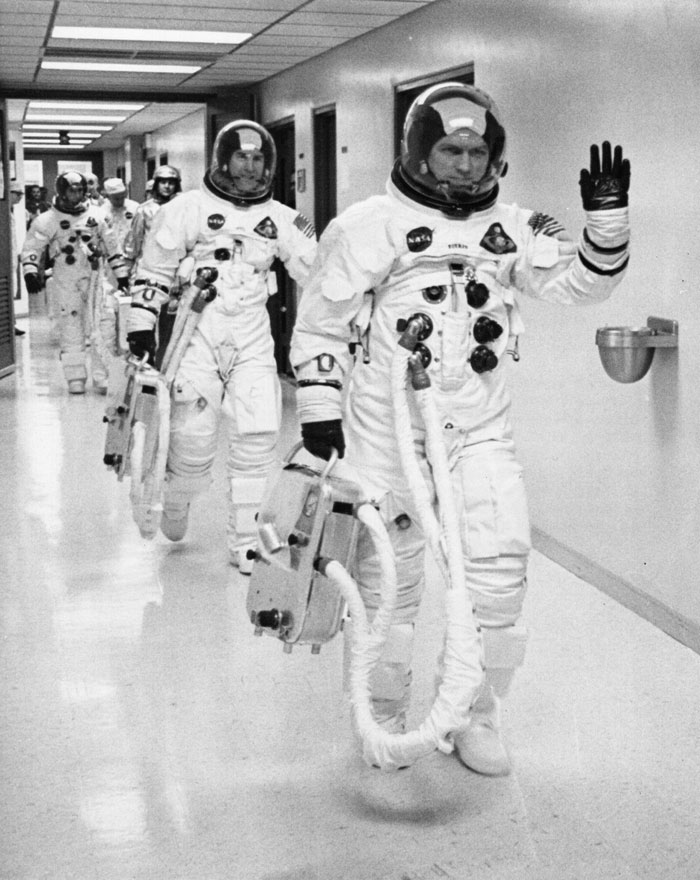 Apollo 8 crew head from the suiting-up room