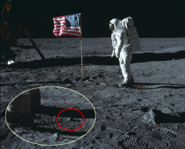 Detail from 5875 showing rock or clump just
                      behind Buzz's boots