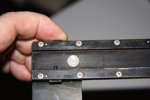 DAC fitting on right angle bracket with button
                  depressed