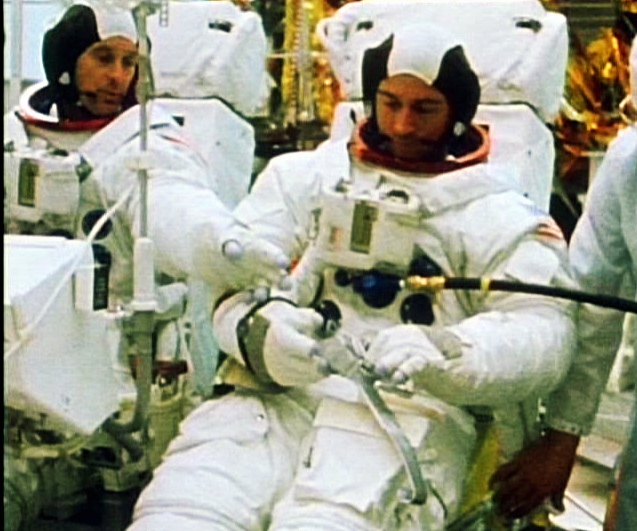 John Young holds his seatbelt